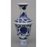 A Chinese blue & white vase decorated with scrolling flowering foliage, 13cms high.