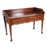 A 19th century oak side table with three quarter galleried top above two frieze drawers, on turned