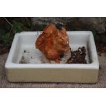 A ceramic butler's sink, 62cms wide together with a garden figure of a squirrel (2)