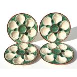 A set of four majolica oyster dishes, each 24cms diameter (4).