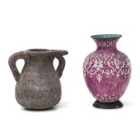 A Persian Isfahan enamelled vase decorated with foliate scrolls on a pink ground, 16cms high;