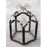 A large hexagonal hall lantern with arched panels and distressed painted metal support, 88cms high.