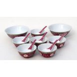 A group of Chinese famille rose rice bowls, spoons and serving bowls decorated with foliate