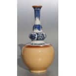 A Chinese vase, the upper section decorated with blue & white flowers and leaves, the lower