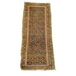 A North West Persia Kurdish long rug, circa 1920, 113.5 by 286.3cms.Condition ReportHas been reduced