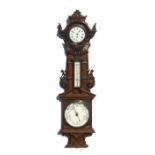 An Edwardian aneroid barometer, thermometer and clock in a carved walnut case, 110cms high.