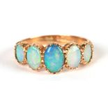 A 9ct gold graduated five-stone opal ring, approx UK size 'M', 3.2g.