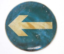 A circular aluminium directional arrow road sign, 60cms diameter.