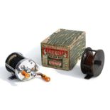 A Pflueger Skilkast multiplier reel, no: 1953, boxed; together with a brass centre pin or winch,