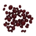 A group of loose cherry amber Bakelite beads, largest bead 24mm long, total weight 111g.