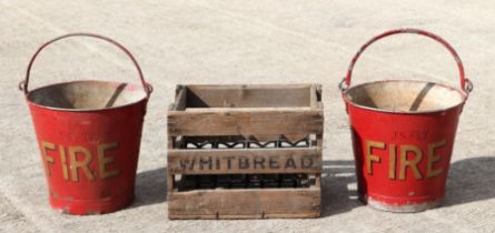 Two red painted galvanised fire buckets with wrought iron hangers; together with a Whitbread Brewery