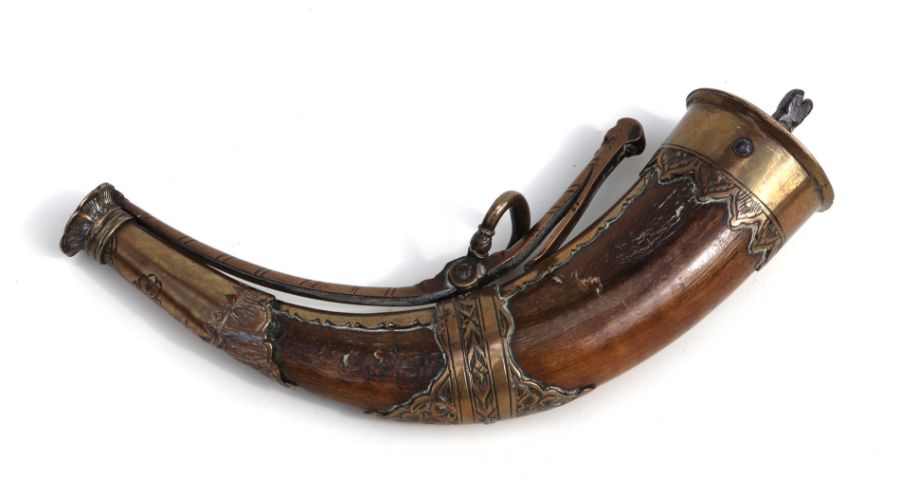 An 18th / 19th century German brass mounted horn powder flask, 21cms wide.
