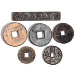 A group of Chinese pierced coins or medallions to include one rectangular example, the largest