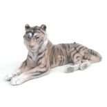 A Royal Copenhagen figure of a recumbent tiger, model no. 714, 31cms long.