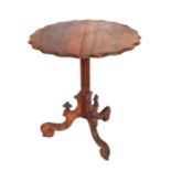 A late Victorian / Edwardian walnut tilt-top occasional table with circular wavy edged top, on a