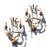 A pair of twin-arm white painted and gilded wall lights, 47cms high (2).