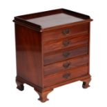 An Edwardian mahogany music cabinet with five drawers and drop-down front, on bracket feet, 48cms