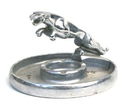A 1960's Jaguar Dealer Showroom aluminium ashtray surmounted with a leaping Jaguar mascot, 18cms