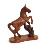 A carved wooden study of a rearing horse, 30cms high.