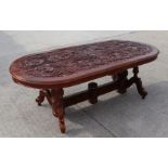 A large Indonesian carved twin-pedestal dining table, 236 by 106cms; together with a matching set of