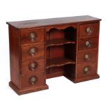 A Victorian mahogany apothecary chest with two banks of four drawers flanking shelves, 102cms wide.