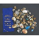 A quantity of costume jewellery to include tie pins, earrings and brooches.