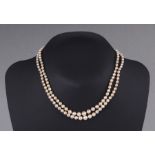 A cultured pearl double strand necklace with silver clasp, 37cms long.