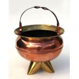 An Arts & Crafts cauldron shaped copper & brass coal scuttle, 33cms diameter.