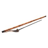 A bamboo shafted sword stick with a 49.5cms (19.5ins) triangular section blade and stag horn handle.