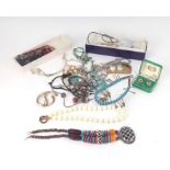 A quantity of costume jewellery to include an ethnic bead necklace.