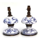 A pair of continental porcelain blue & white table lamps, 25cms high. (a/f)
