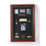 A modern fishing tackle diorama depicting floats, reels and a creel, framed & glazed, overall 35