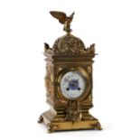 A 19th century mantle clock, the white enamel dial with Arabic numerals, the movement striking on