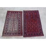 A Persian prayer rug with repeated geometric pattern on a red ground, 128 by 80cms; together with