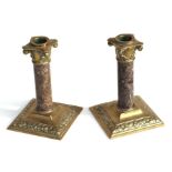 A pair of Victorian cast brass and polished granite Corinthian column candlesticks, 17cms high (2).