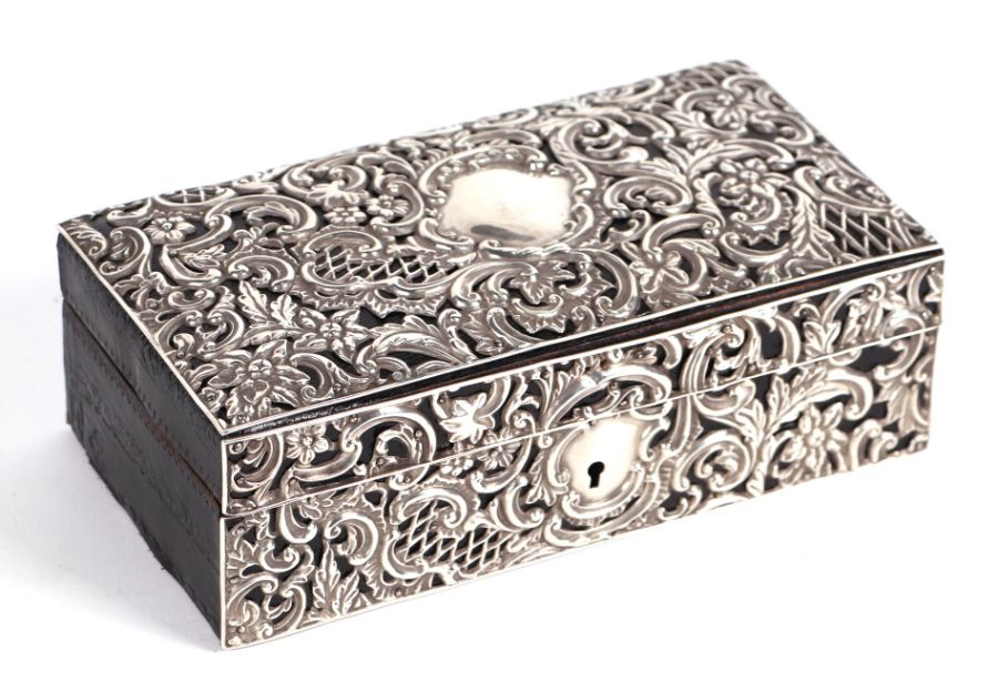 A Victorian leather jewellery box clad with silver repousse decoration, Chester 1896, 21cms wide.