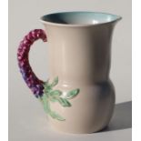 A Clarice Cliff jug with vine twist handle, shape number 677, 19cms high.