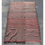 A large vintage flatweave rug or wall hanging with repeated diamond design on a red ground, 255 by