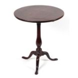 A George III mahogany tilt-top tripod table with vase shaped column on tripod base with slipper