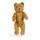 A vintage plush teddy bear with long limbs and hump back, approx 30cms high.