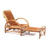 A bamboo and wicker work planter's type chair with adjustable back and foot rest.