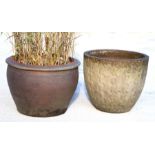 A large garden pot, 60cms diameter; together with another similar, 48cms diameter (2).