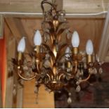 A six-branch gilt metal ceiling light with glass prismatic drops.