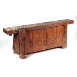 A rustic wooden workbench with large vice, 168cms wide.Condition ReportThe structure is sound but