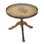 A tripod occasional table with circular top and painted floral decoration, 60cms diameter.