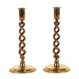 A pair of 19th century brass double open spiral twist candlesticks on stepped circular bases,