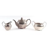 A Victorian silver three-piece tea service with chased decoration and armorial, London 1878, 1188g.