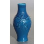 A Chinese monochrome blue glaze baluster vase with bow decoration, impressed mark to base, 18cms