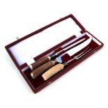 A Fortnum & Mason antler handled three-piece carving set, cased.