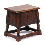 A 17th century style oak box joint stool, the frieze with carved decoration, 46cms wide.